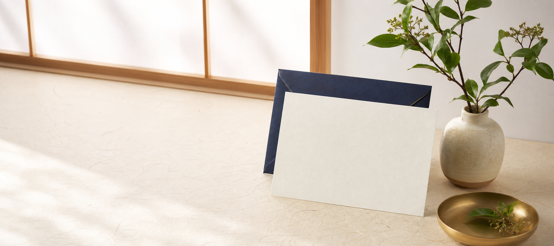 Elegant Japanese stationery beside a seasonal green branch